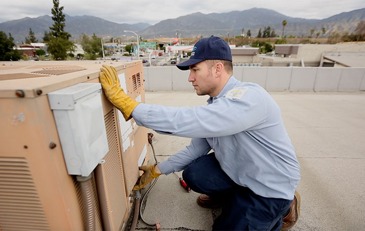 expert commercial HVAC maintenance Air-Tro technician performing commercial HVAC maintenance on Pasadena rooftop unit