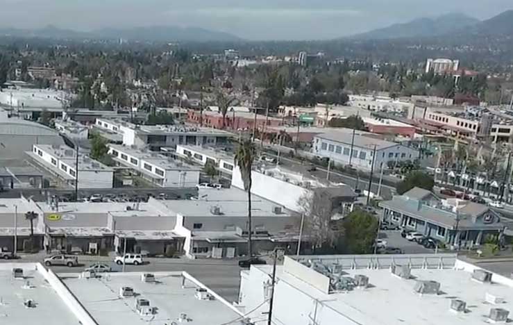 Commercial HVAC technician inspecting chiller on Los Angeles rooftop